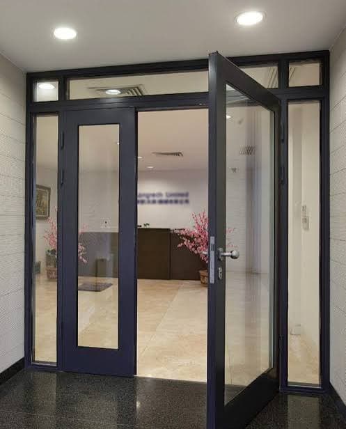 Navy-framed commercial glass storefront entry door